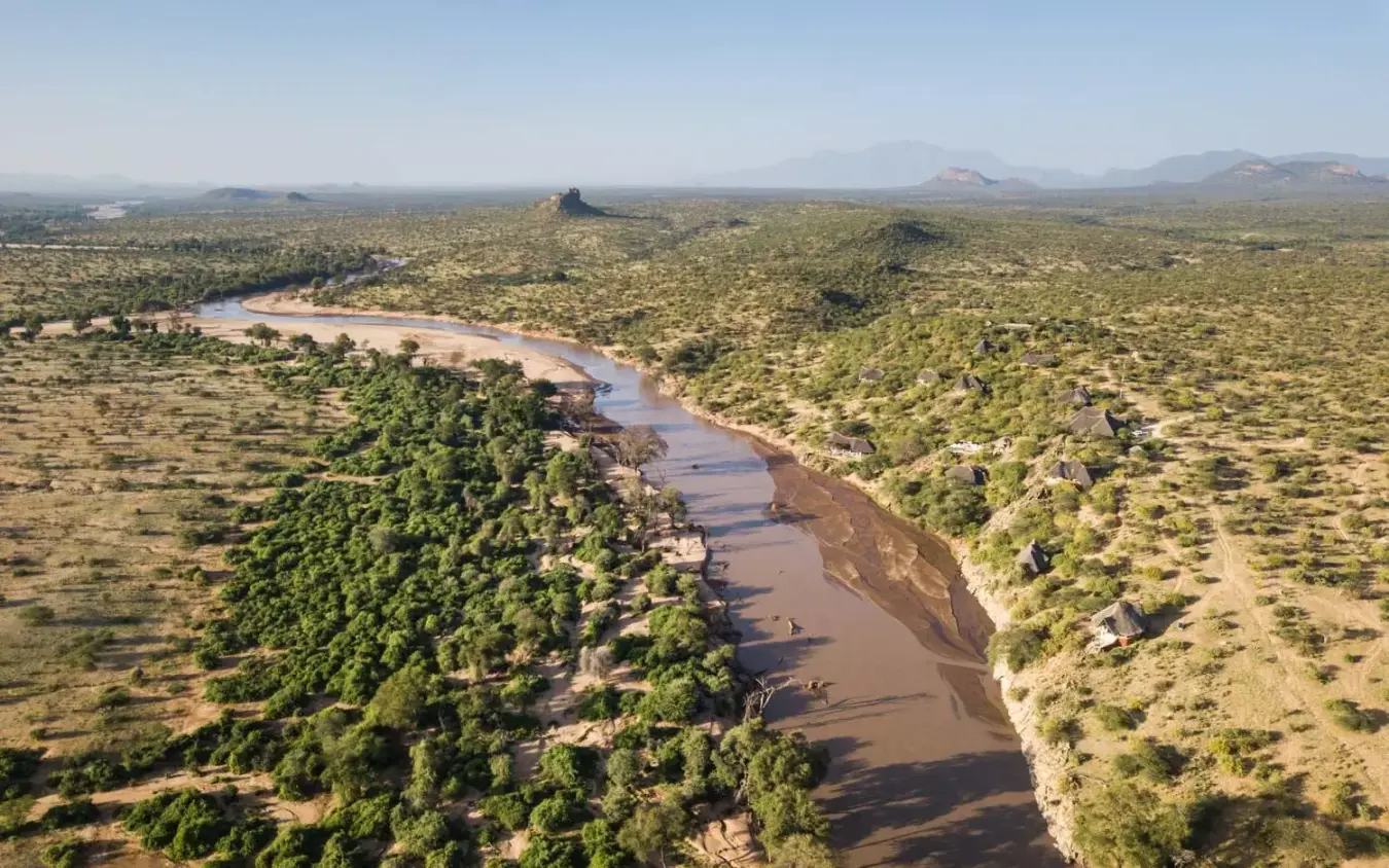 Winding river through savanna woodland with distant volcanic peaks, Sasaab, Samburu Reserve, Kenya