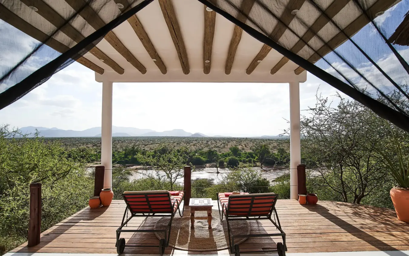Wooden deck overlooking river and acacia woodland landscape, Sasaab, Samburu Reserve, Kenya