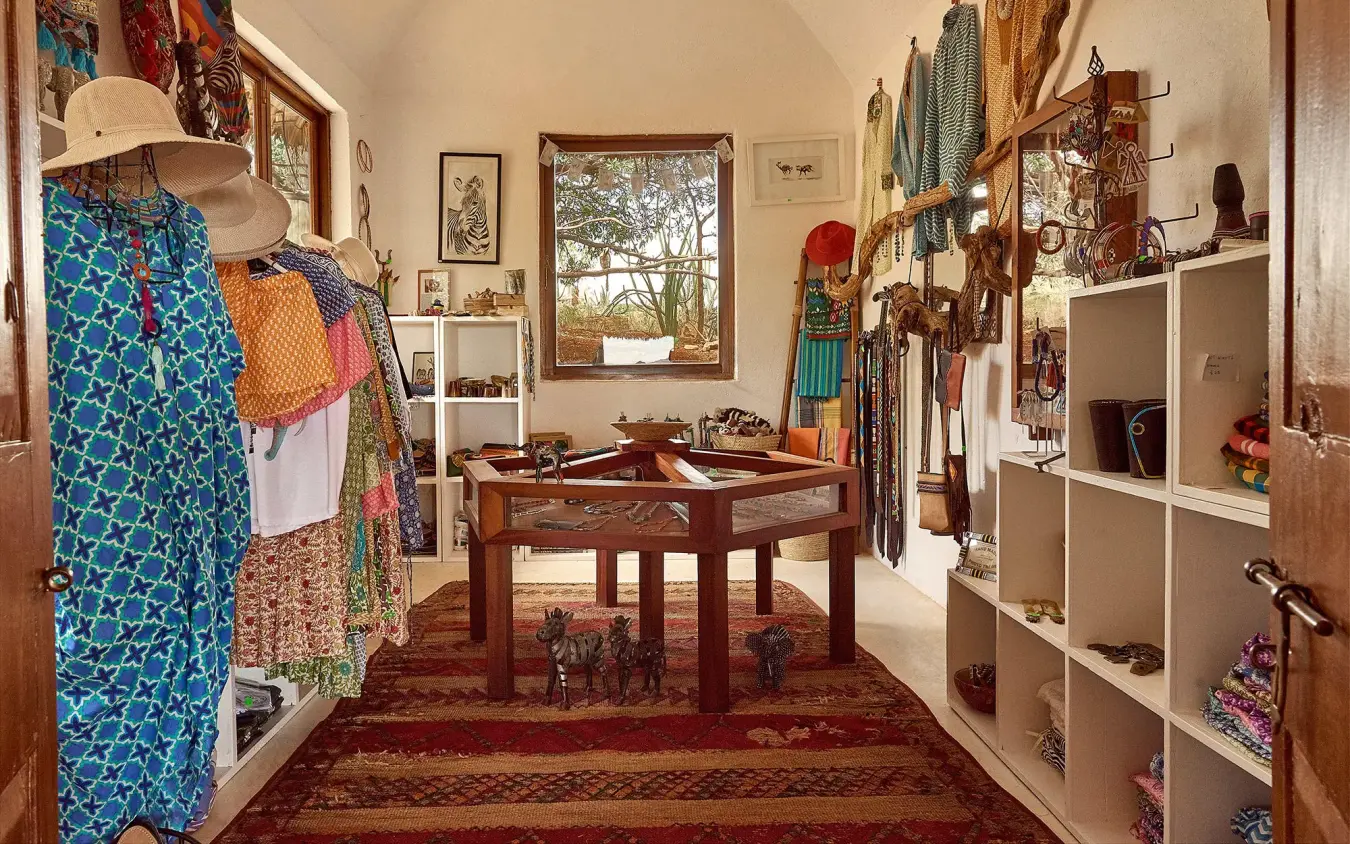 Interior retail shop displaying colorful textiles and accessories, Sasaab, Samburu Reserve, Kenya