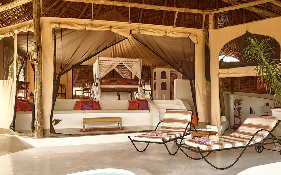 Luxury bedroom pavilion with canopy bed and loungers, Sasaab, Samburu Reserve, Kenya