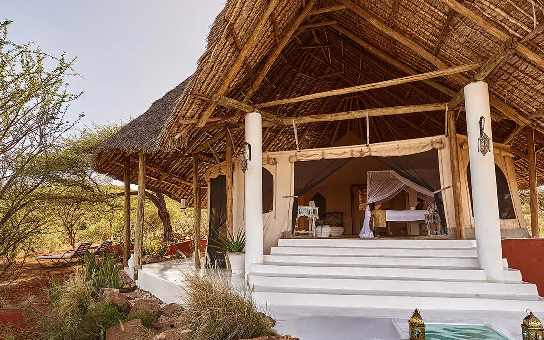 Thatched roof lodge with white columns and pool area, Sasaab, Samburu Reserve, Kenya