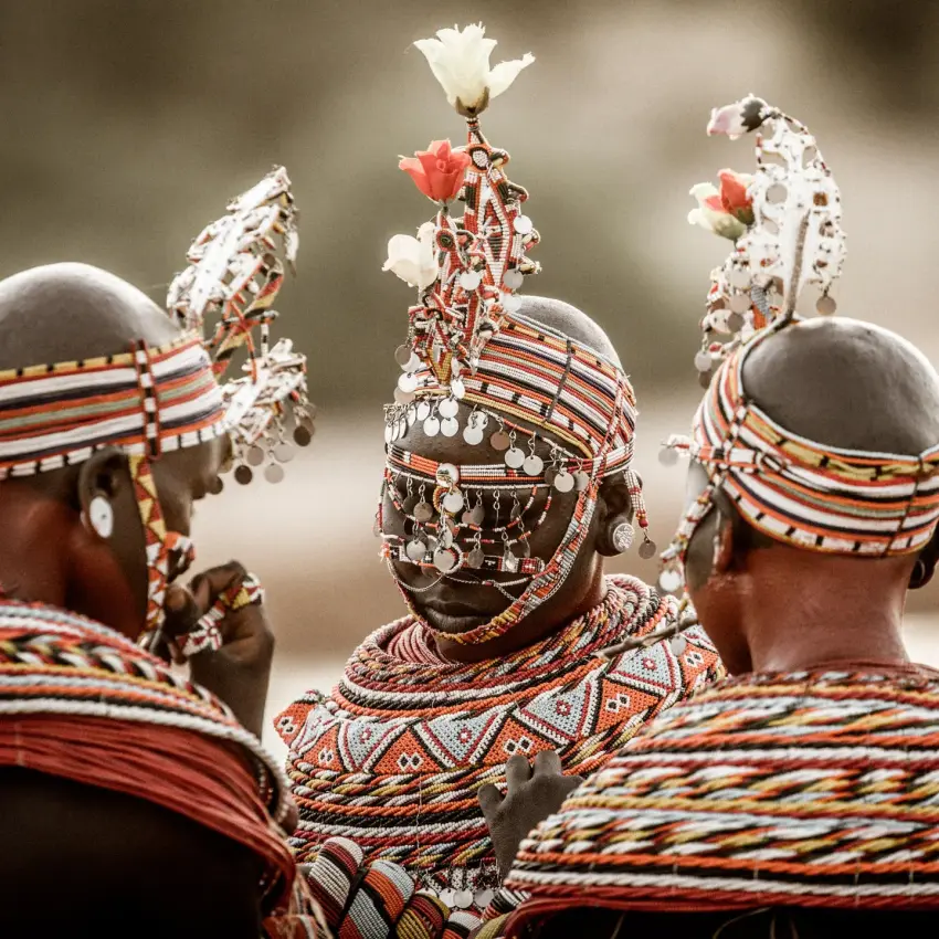 Three warriors in traditional beaded regalia from behind, Sasaab, Samburu Reserve, Kenya