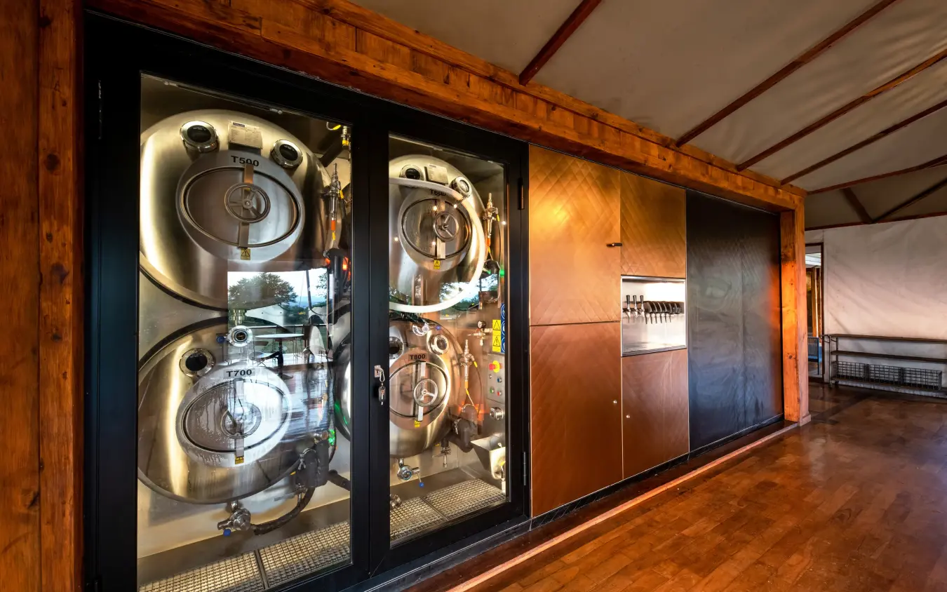 Industrial laundry equipment displayed behind glass doors, Sayari Camp, Serengeti National Park, Tanzania