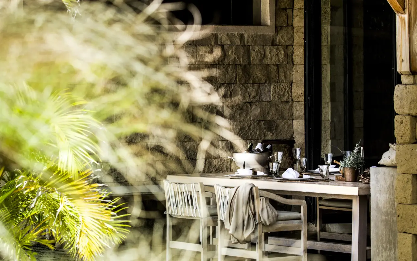 Outdoor vanity desk with chairs overlooking stone architecture, Segera, Laikipia Highlands, Kenya