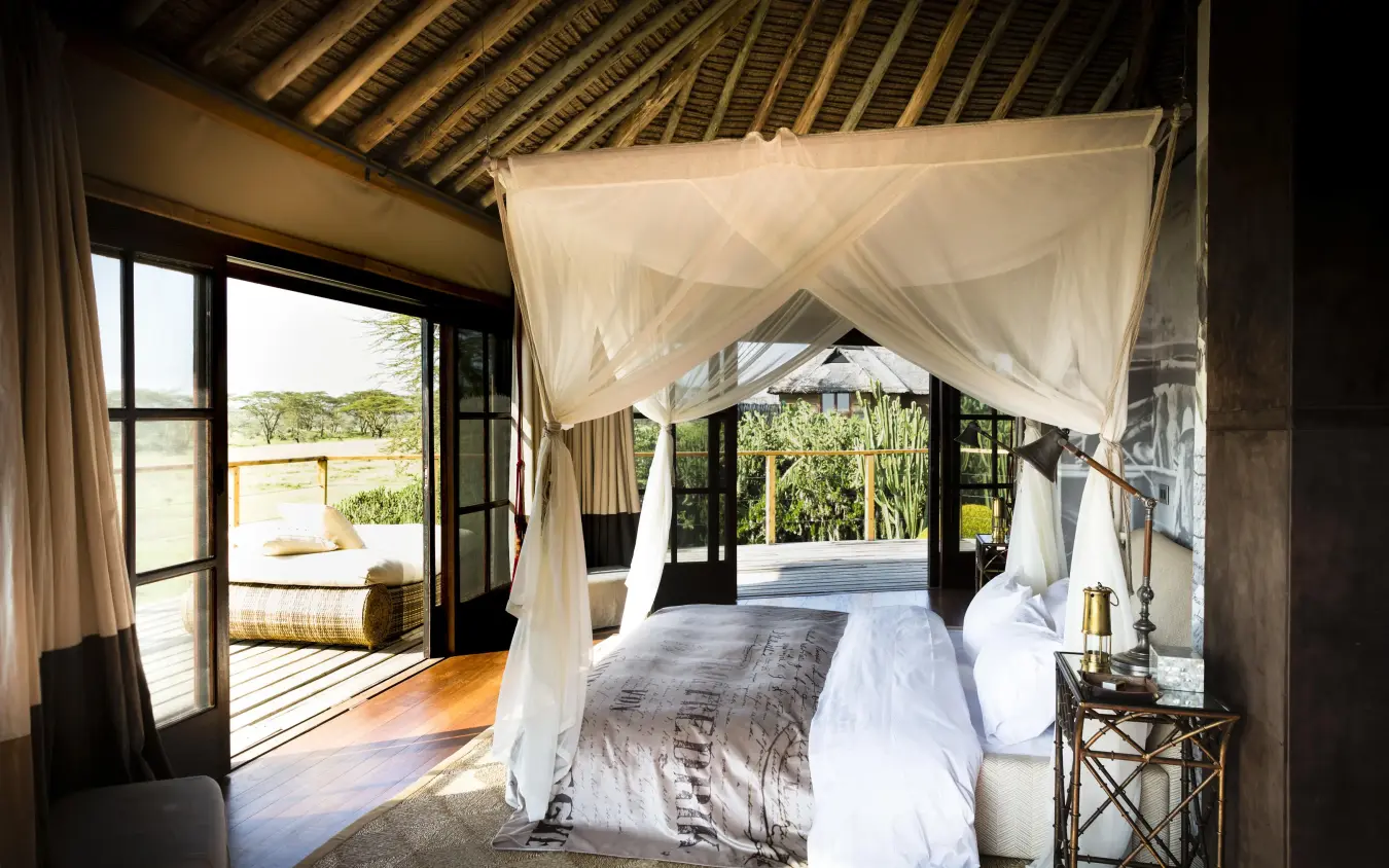 Canopy bed in open-air bedroom with landscape views, Segera, Laikipia Highlands, Kenya