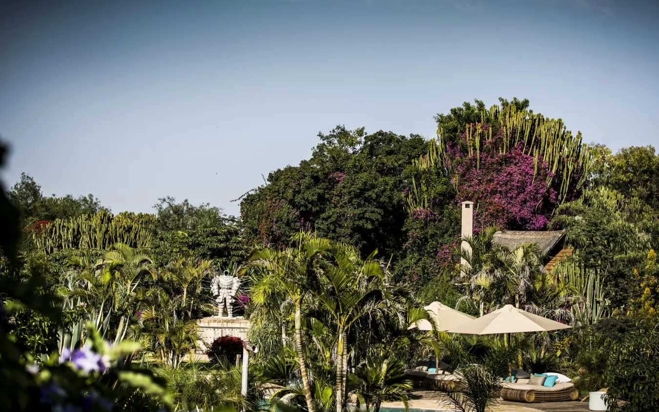Luxury poolside retreat with lush tropical gardens and loungers, Segera, Laikipia Highlands, Kenya