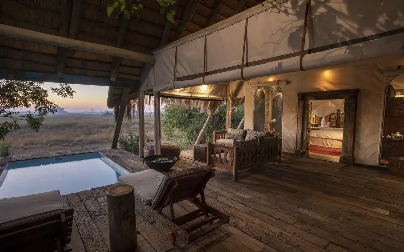 Wooden deck with pool overlooking savanna at dusk, Selinda Camp, Selinda Reserve, Botswana