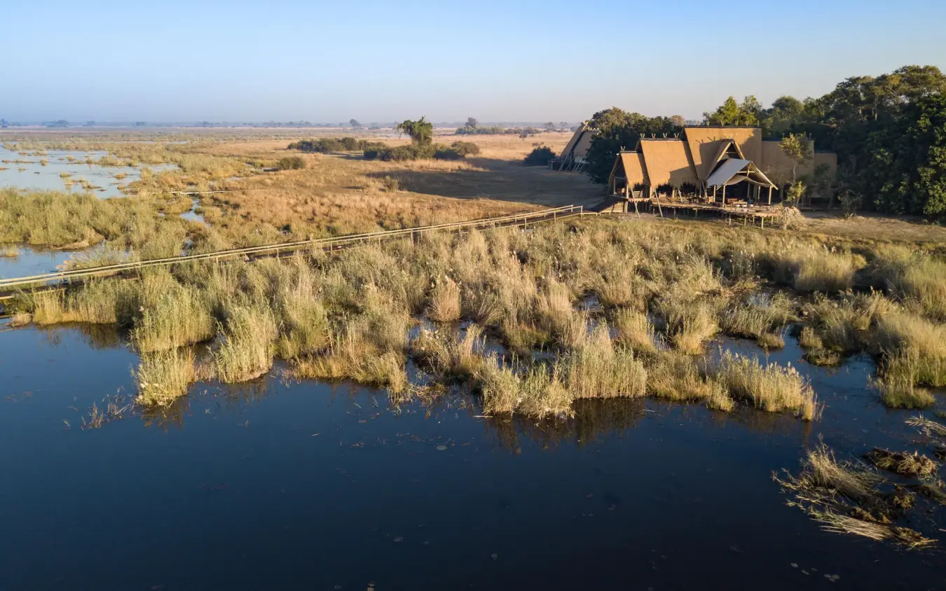 Aerial view of luxury lodge overlooking wetland with reed beds, Selinda Camp, Selinda Reserve, Botswana