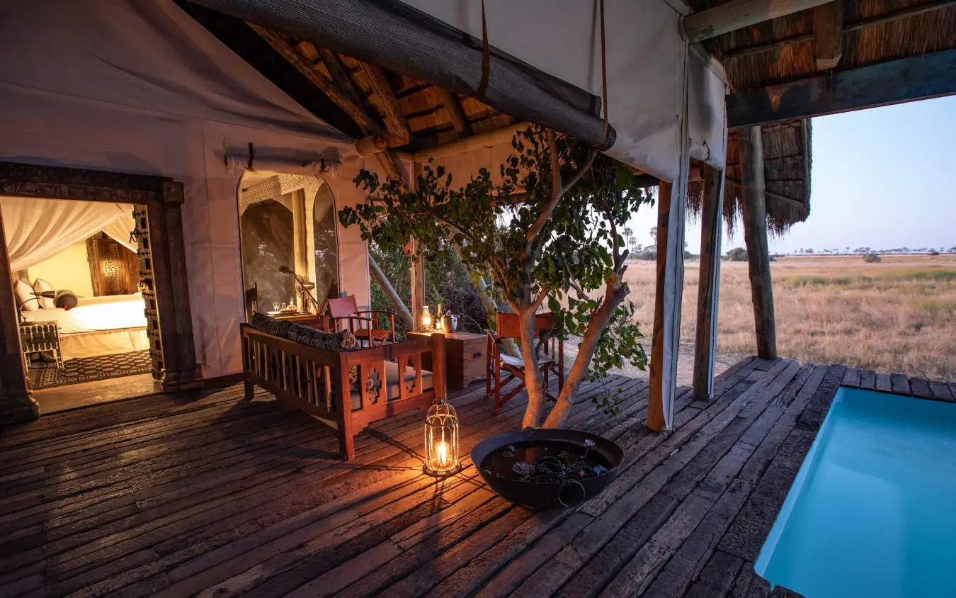 Wooden deck at dusk with pool and bedroom pavilion, Selinda Camp, Selinda Reserve, Botswana