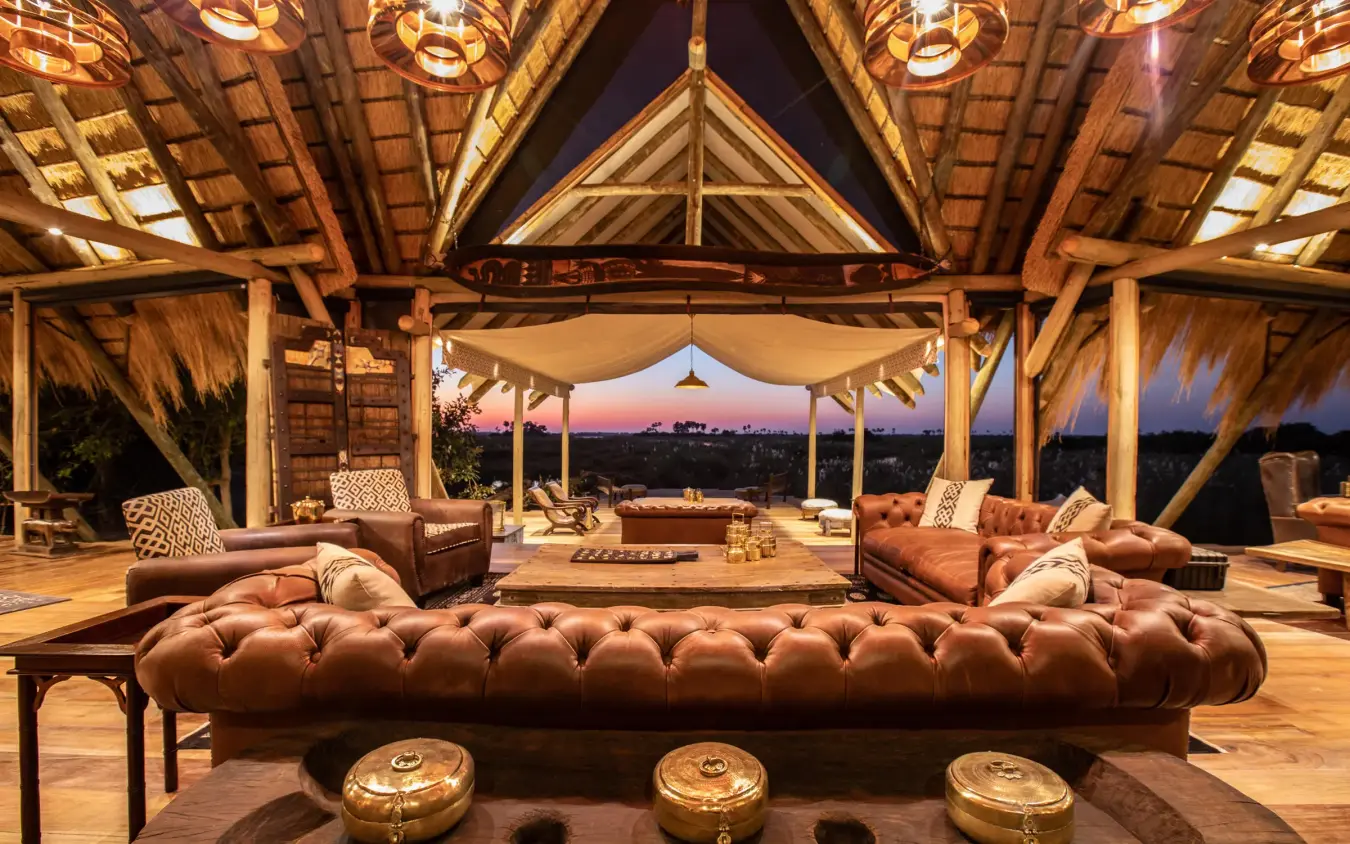 Open-air lounge with leather seating and sunset views, Selinda Camp, Selinda Reserve, Botswana