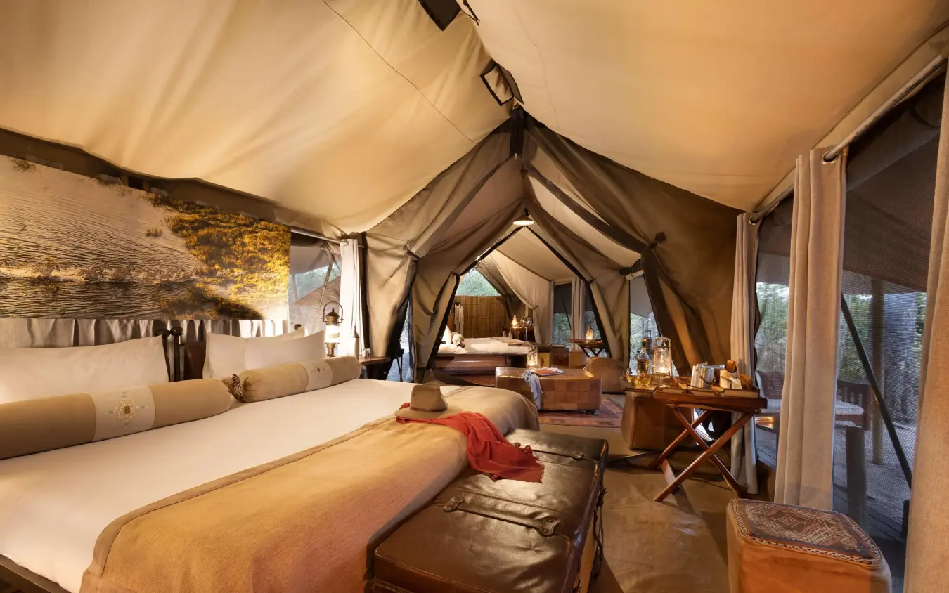 Luxury safari tent bedroom with canvas walls and furnishings, Selinda Explorers Camp, Selinda Reserve, Botswana