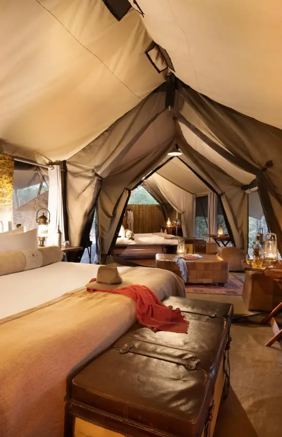 Luxury safari tent bedroom with canvas walls and furnishings, Selinda Explorers Camp, Selinda Reserve, Botswana