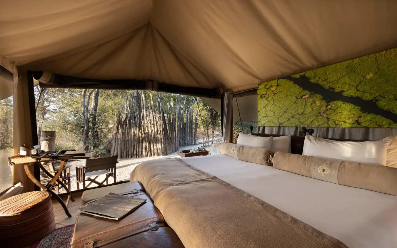 Luxury safari tent bedroom with forest views and natural light, Selinda Explorers Camp, Selinda Reserve, Botswana