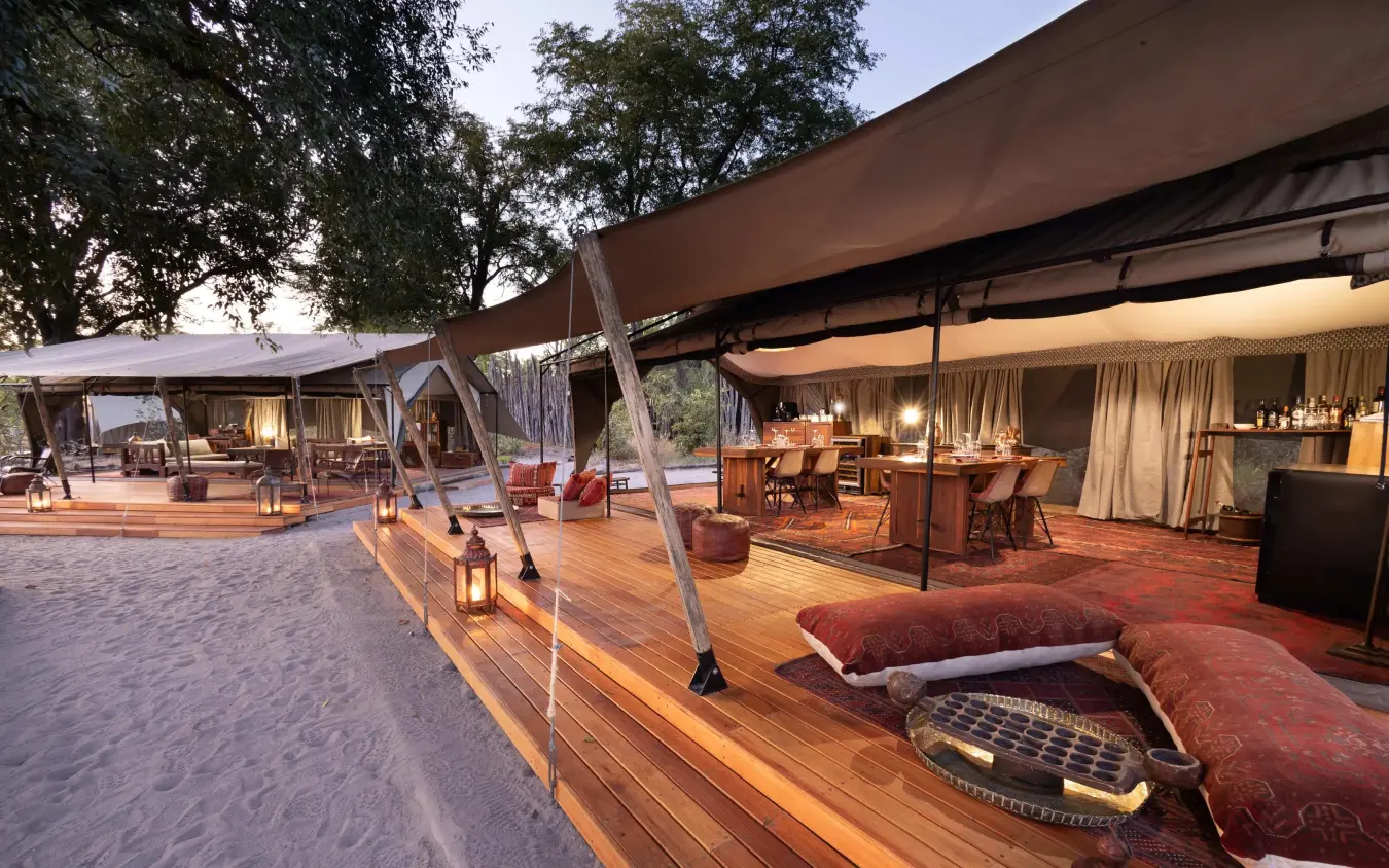 Expansive safari lodge lounge area with wooden decking and canvas, Selinda Explorers Camp, Selinda Reserve, Botswana