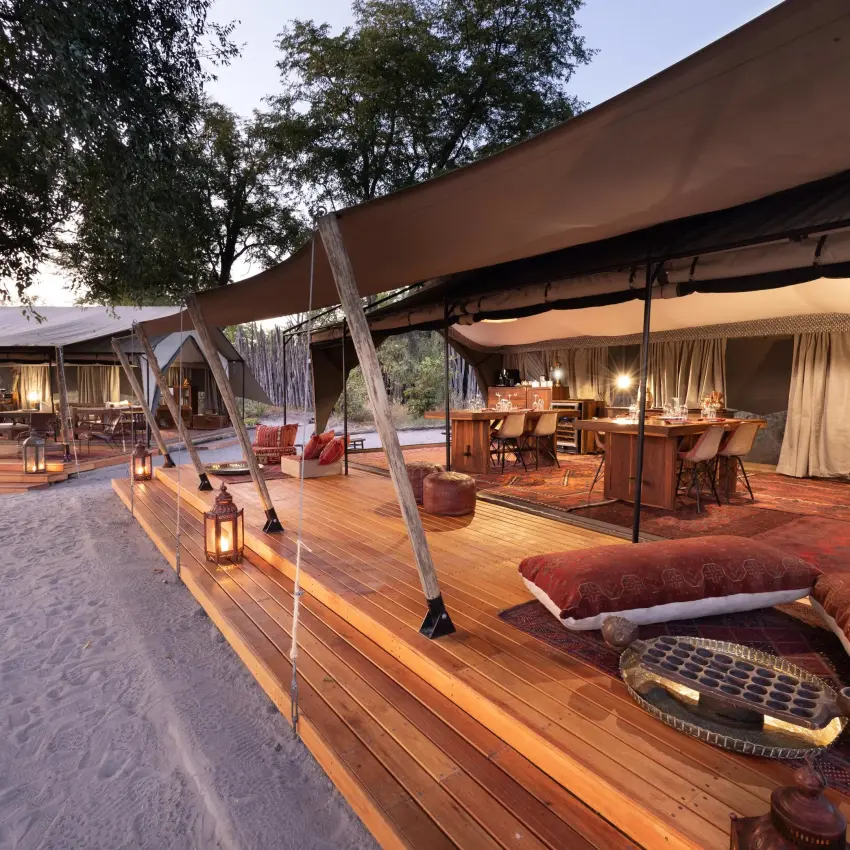 Expansive safari lodge lounge area with wooden decking and canvas, Selinda Explorers Camp, Selinda Reserve, Botswana