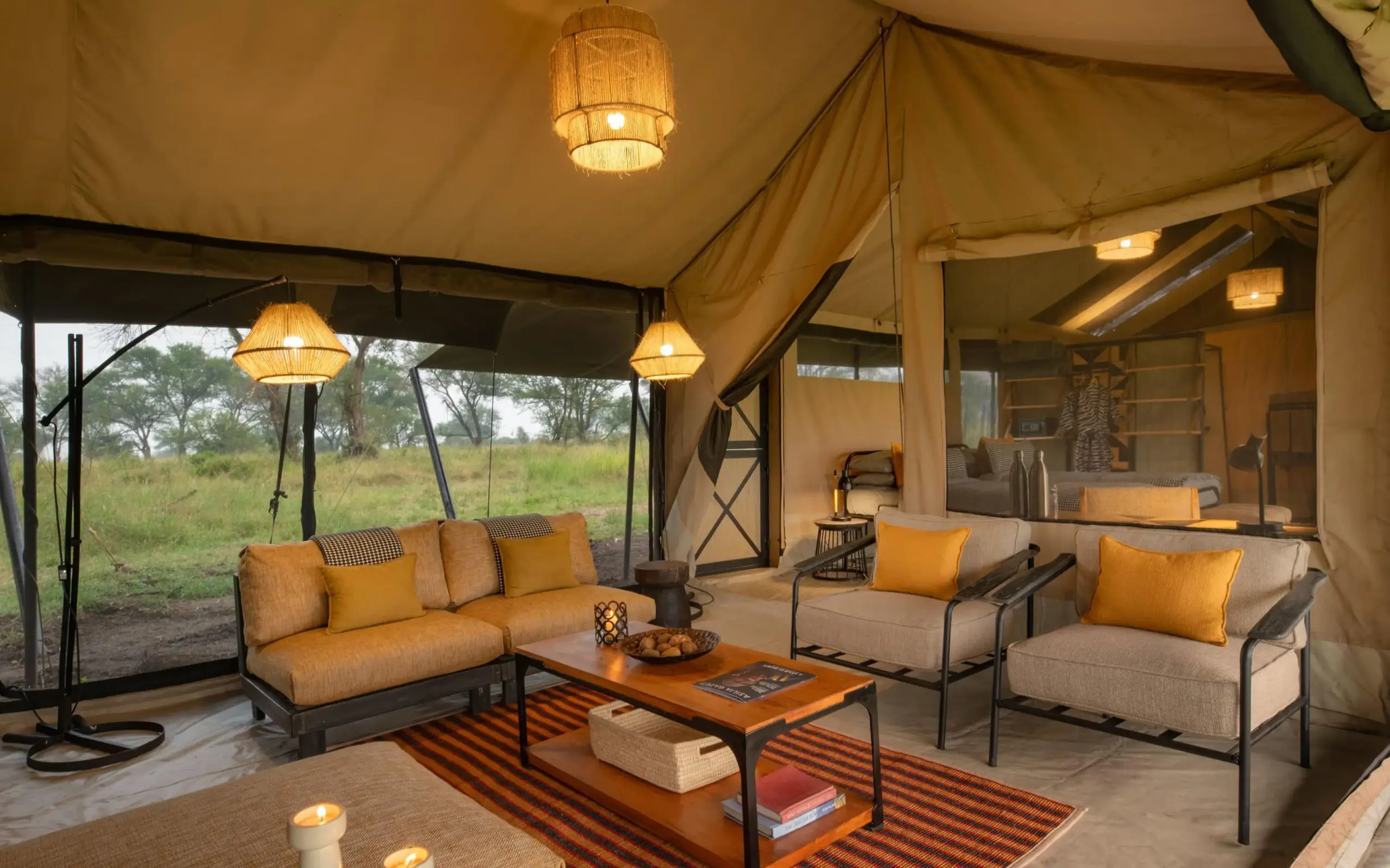 Safari tent lounge with canvas walls and savanna view, Ubuntu Migration Camp, Serengeti National Park, Tanzania