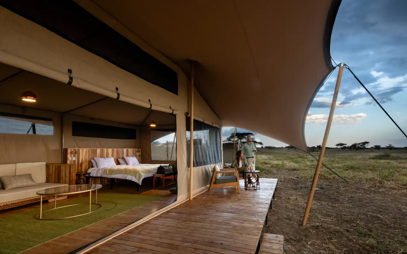 Safari tent bedroom with deck overlooking plains landscape, Serengeti Plains Camp, Serengeti National Park, Tanzania