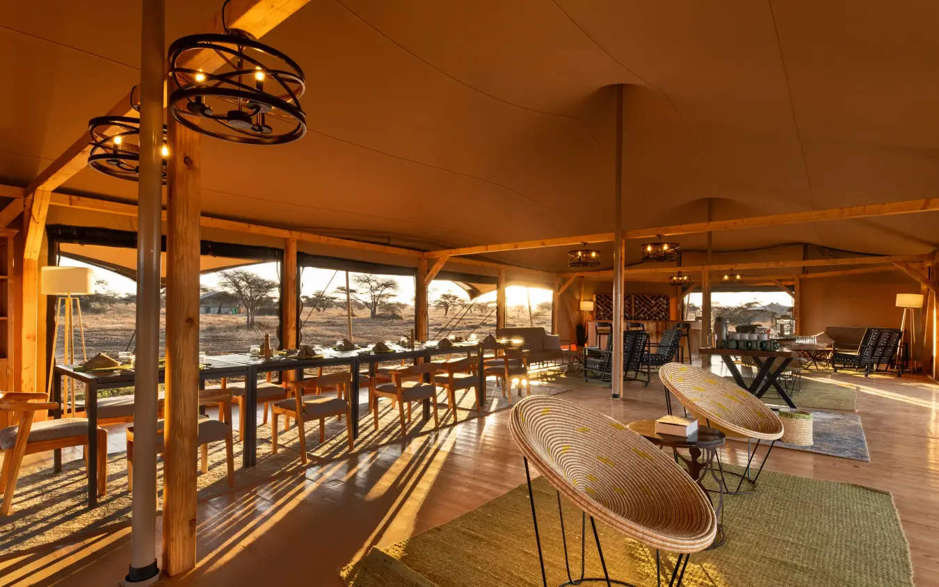 Open-sided lounge tent with dining area and savanna views, Serengeti Plains Camp, Serengeti National Park, Tanzania