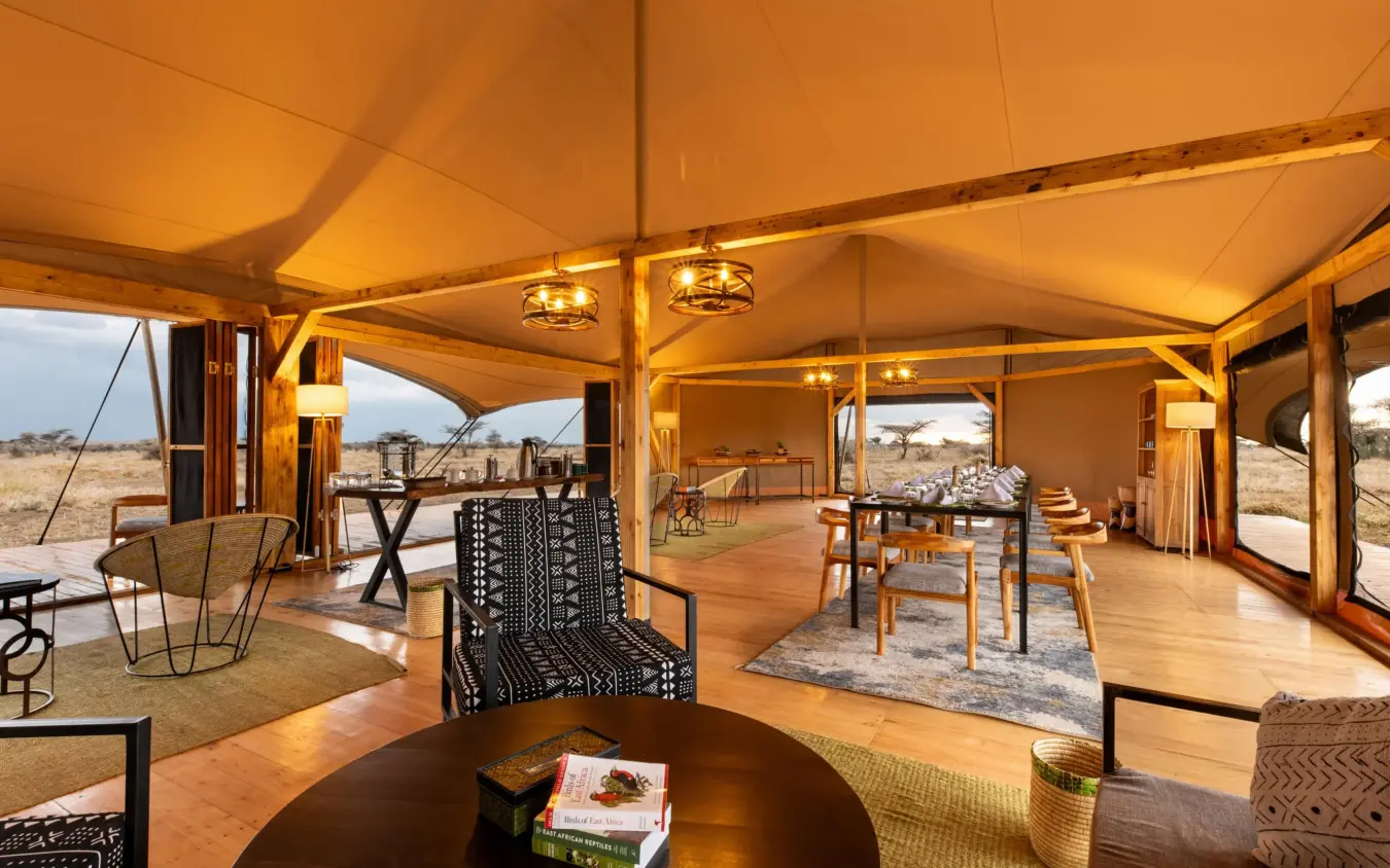 Canvas tent interior with wooden furnishings and savanna views, Serengeti Plains Camp, Serengeti National Park, Tanzania