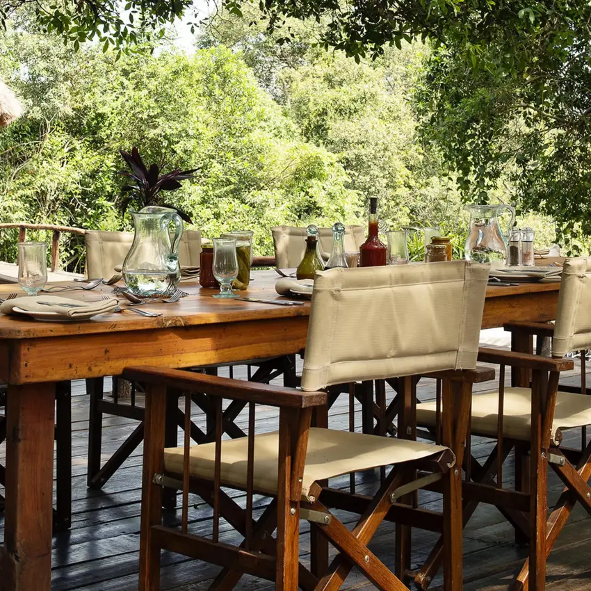 Outdoor dining setup beneath acacia trees and natural shade, Serian “The Original”, Maasai Mara, Kenya