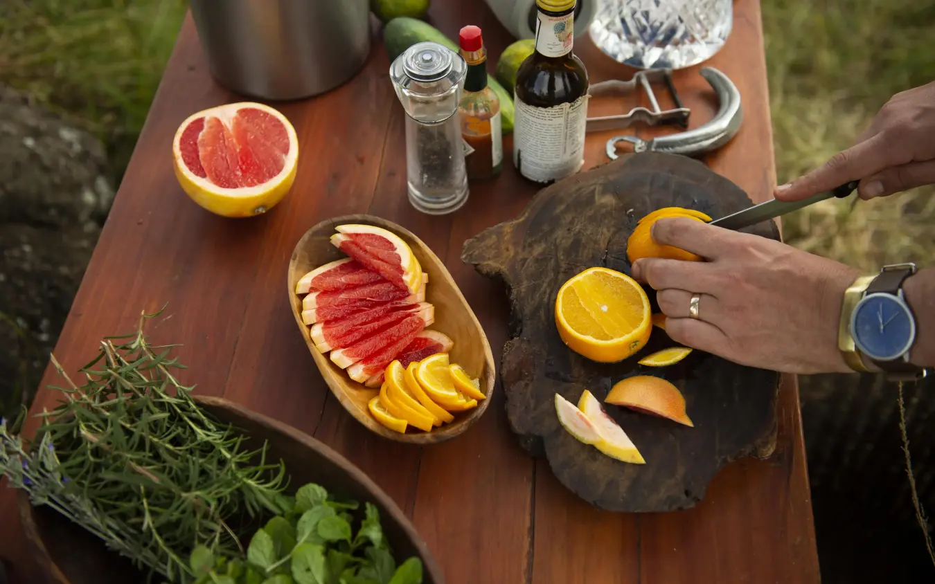 Outdoor food preparation with fresh citrus and sliced meats, Serian “The Original”, Maasai Mara, Kenya