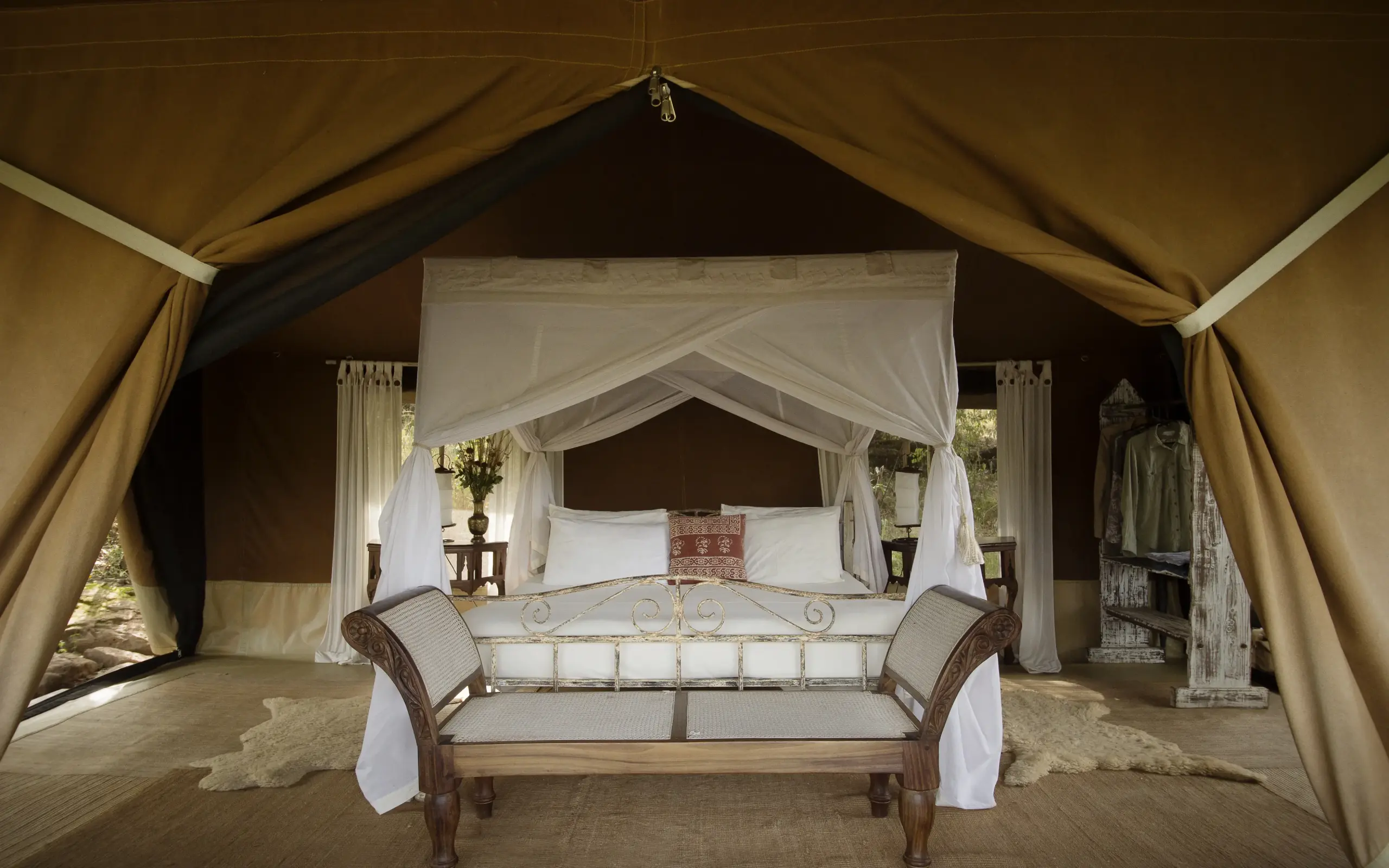 Luxury safari tent bedroom with four-poster bed and seating, Serian “The Original”, Maasai Mara, Kenya