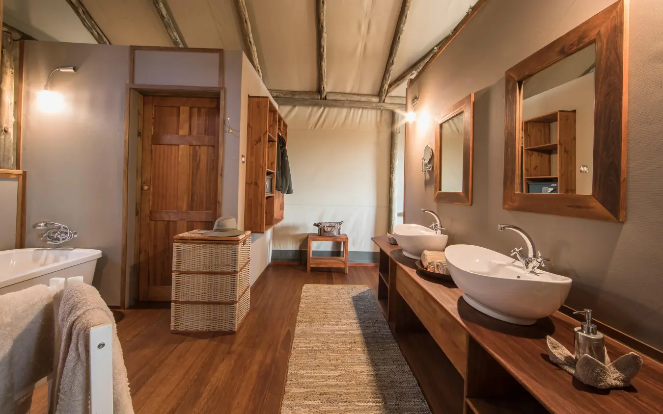 Luxury bathroom with dual vessel sinks and wooden furnishings, Setari, The Okavango Delta, Botswana