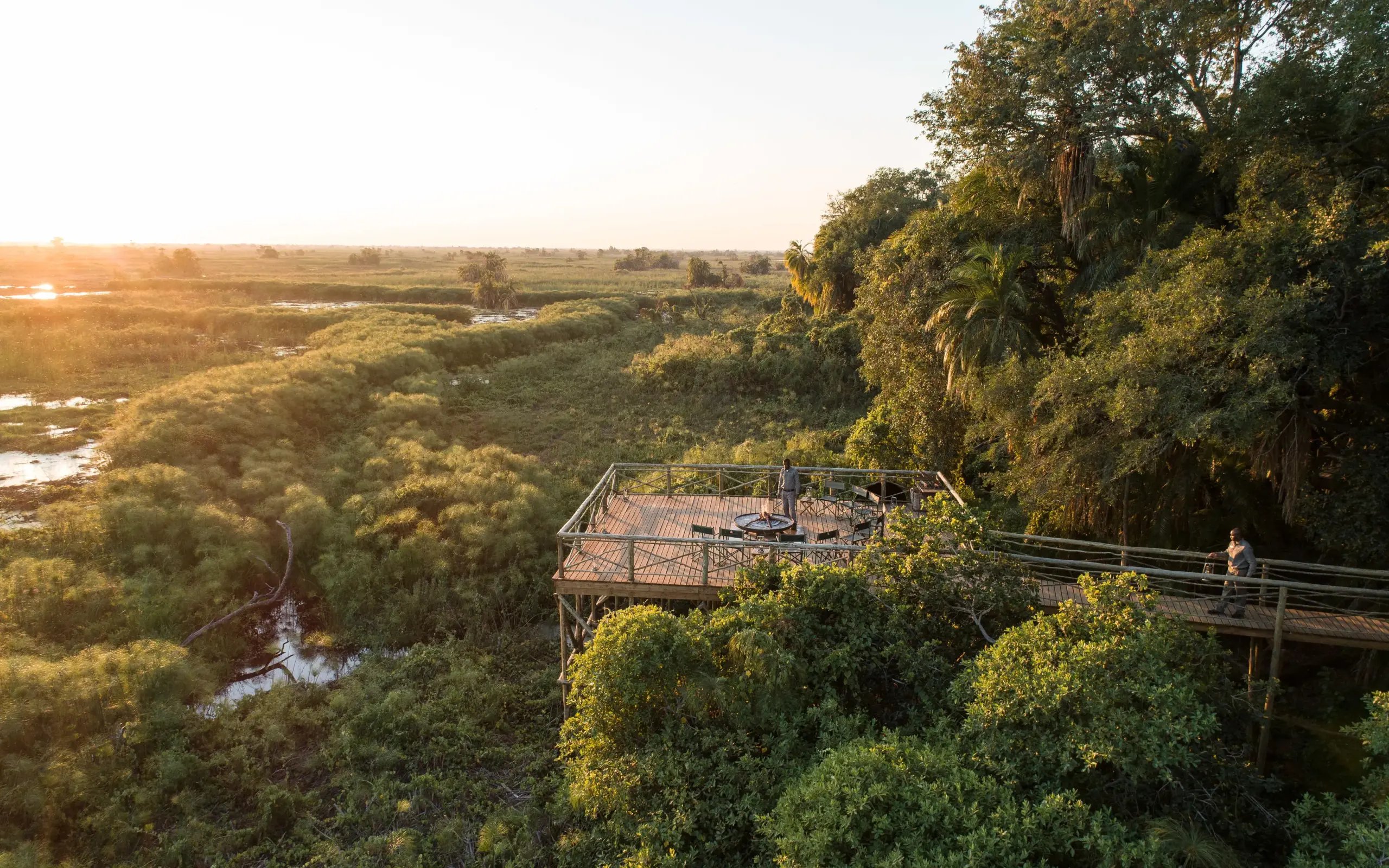 Elevated wooden deck overlooking wetlands and forest canopy, Setari, The Okavango Delta, Botswana