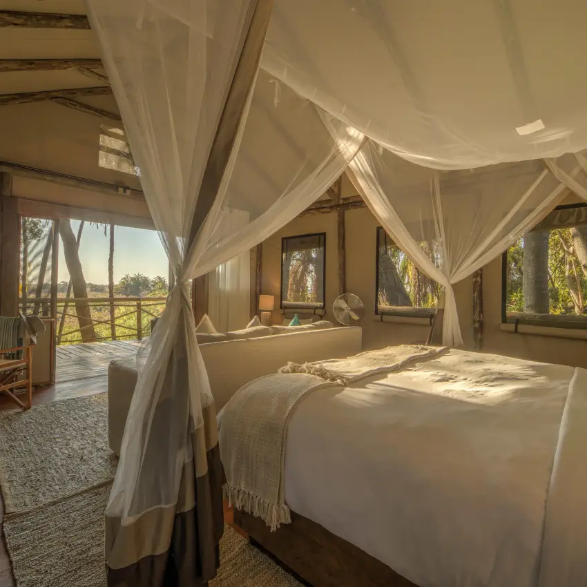 Luxury bedroom with sheer canopy bed and landscape views, Setari, The Okavango Delta, Botswana
