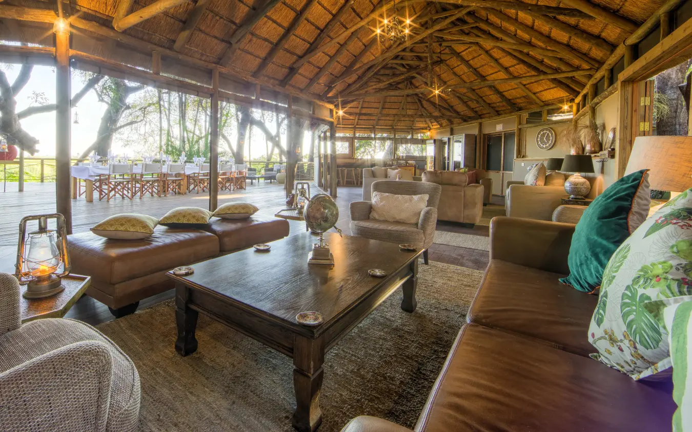 Interior lounge with seating overlooking safari landscape, Setari, The Okavango Delta, Botswana