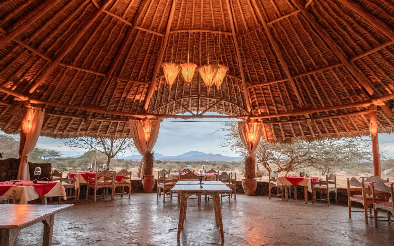 Open-sided dining pavilion with mountain views at dusk, Severin Safari Camp, Tsavo, Kenya