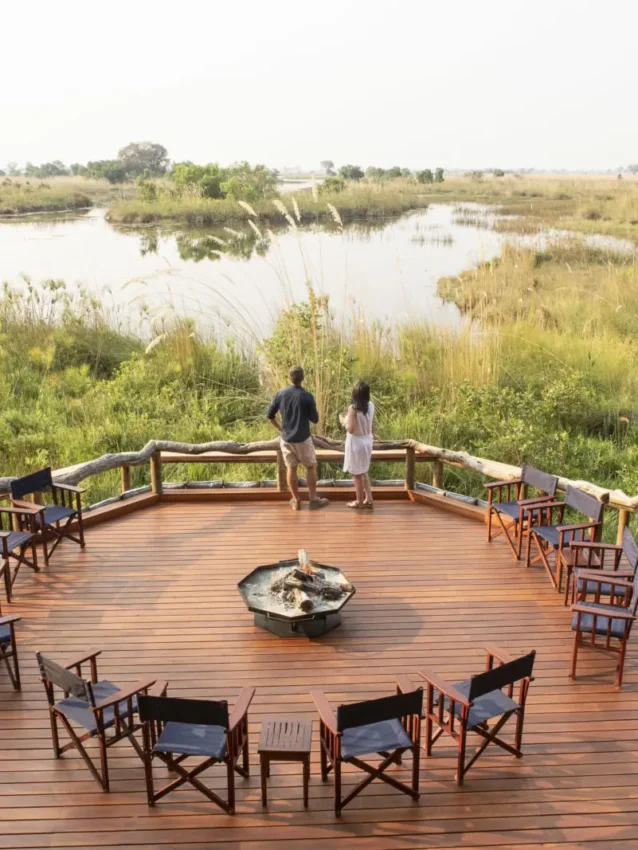 Wooden deck with chairs overlooking wetland landscape, Shinde, The Okavango Delta, Botswana