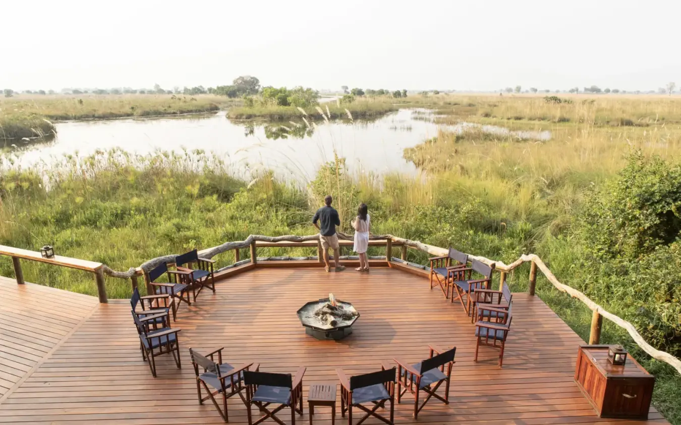 Wooden deck with chairs overlooking wetland landscape, Shinde, The Okavango Delta, Botswana
