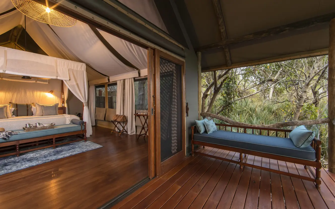Luxury safari bedroom with deck overlooking trees, Shinde, The Okavango Delta, Botswana