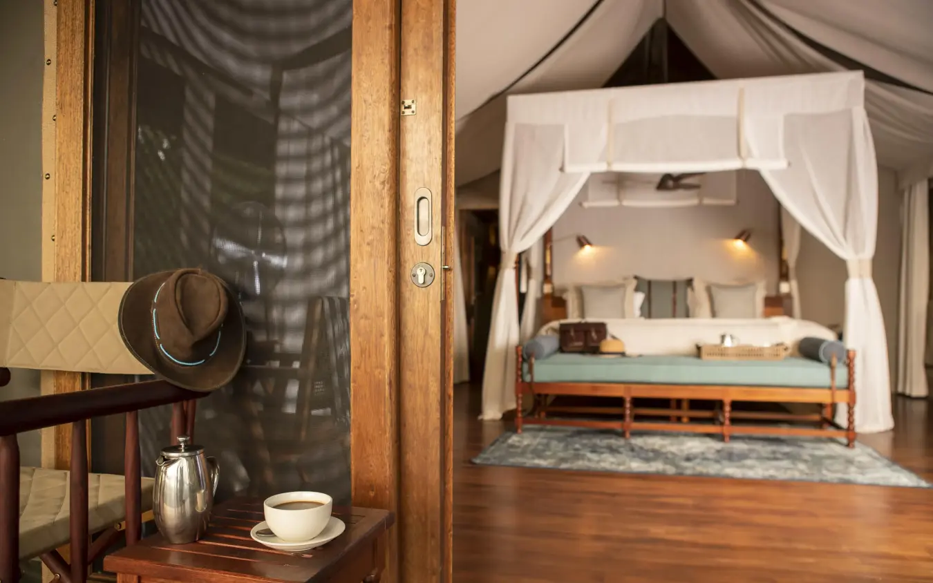 Luxury bedroom with four-poster bed and white drapes, Shinde, The Okavango Delta, Botswana