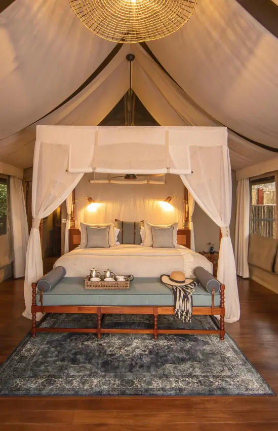 Luxurious safari tent bedroom with canopy bed and draped ceiling, Shinde, The Okavango Delta, Botswana