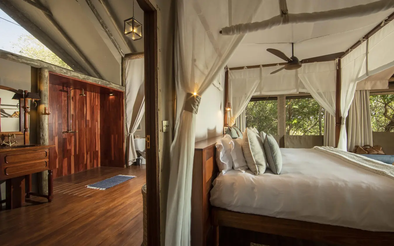Luxury bedroom with four-poster bed and sheer canopy drapes, Shinde, The Okavango Delta, Botswana