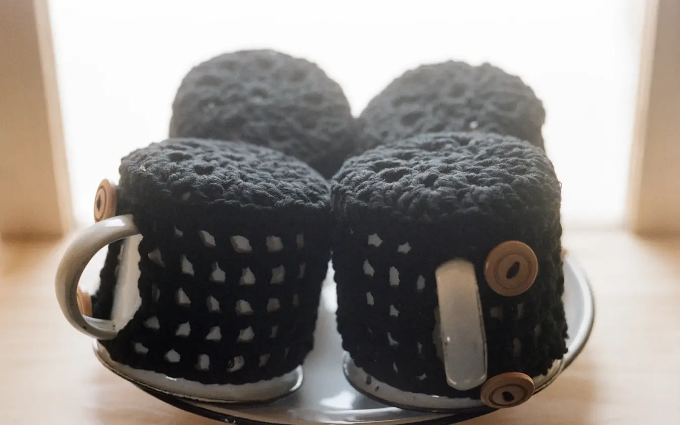 Black knitted slippers with metal handles and copper details, Shipwreck Lodge, Skeleton Coast, Namibia