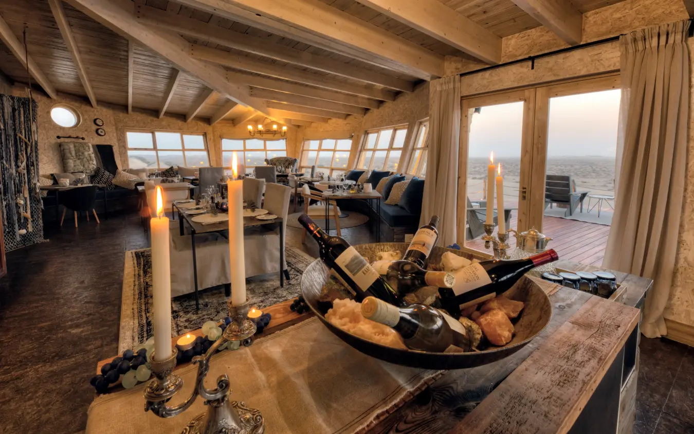 High-altitude interior lounge with expansive windows overlooking landscape, Shipwreck Lodge, Skeleton Coast, Namibia