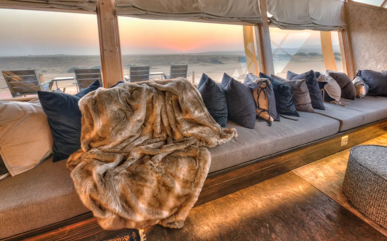 Canvas lounge with ocean view at sunset, Shipwreck Lodge, Skeleton Coast, Namibia