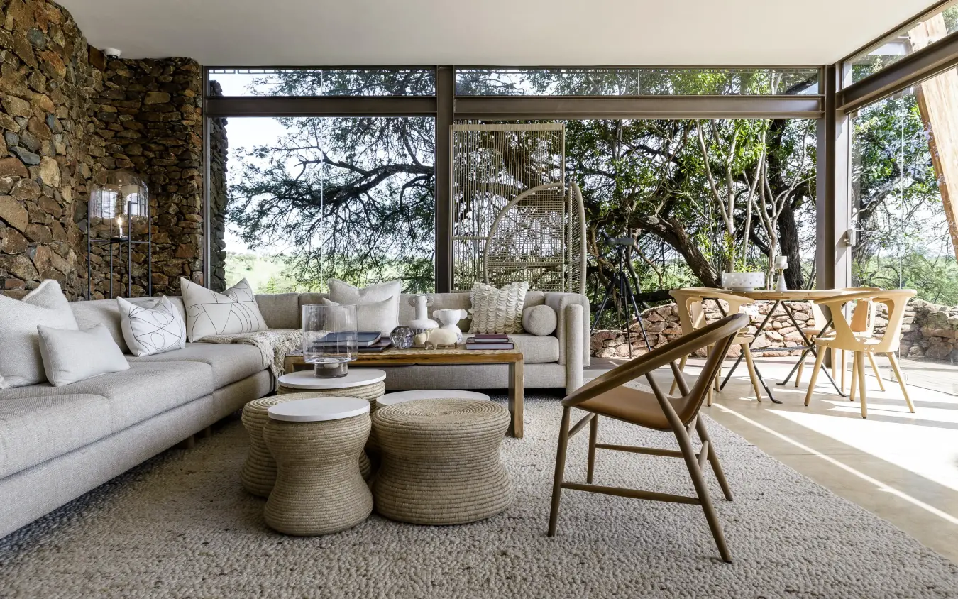 Modern lounge with large windows overlooking natural landscape, Singita Faru Faru Lodge, Serengeti National Park, Tanzania