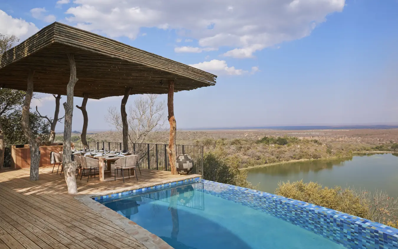 Infinity pool overlooking river valley with wooden pavilion and dining area, Singita Malilangwe House, Gonarezhou & Malilangwe, Zimbabwe