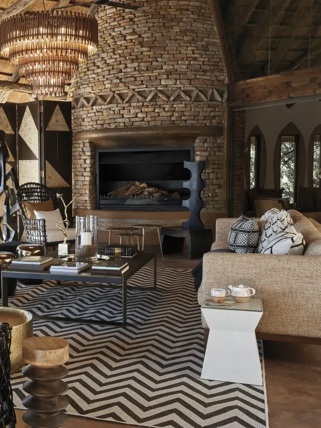 Open-air lounge with fireplace and woven furnishings, Singita Pamushana, Gonarezhou & Malilangwe, Zimbabwe
