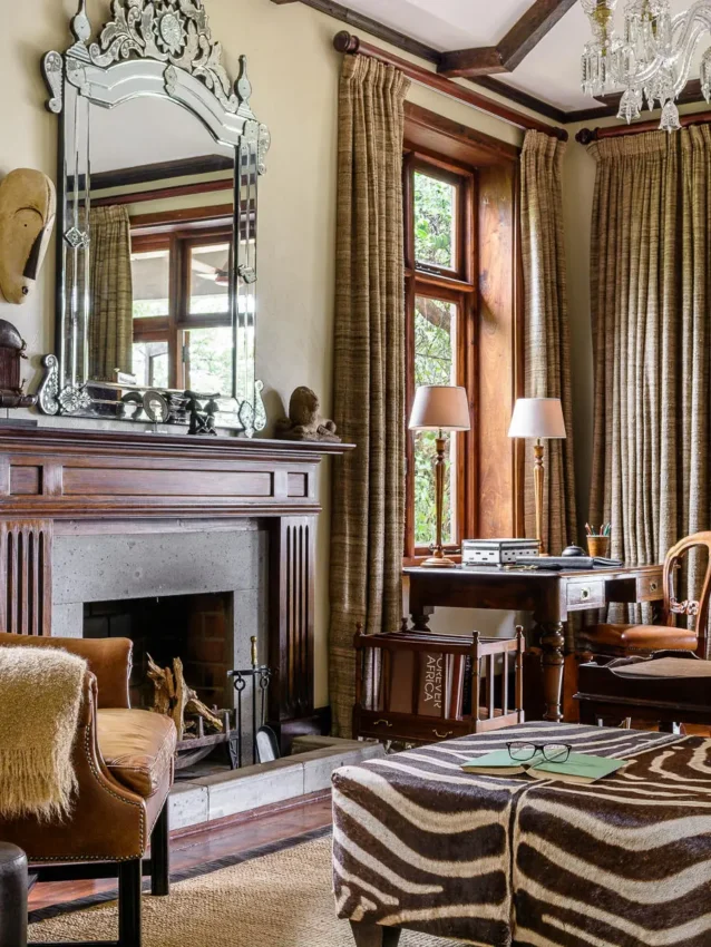 Elegant living room with fireplace, mirror, and gold accents, Singita Sasakwa Lodge, Serengeti National Park, Tanzania