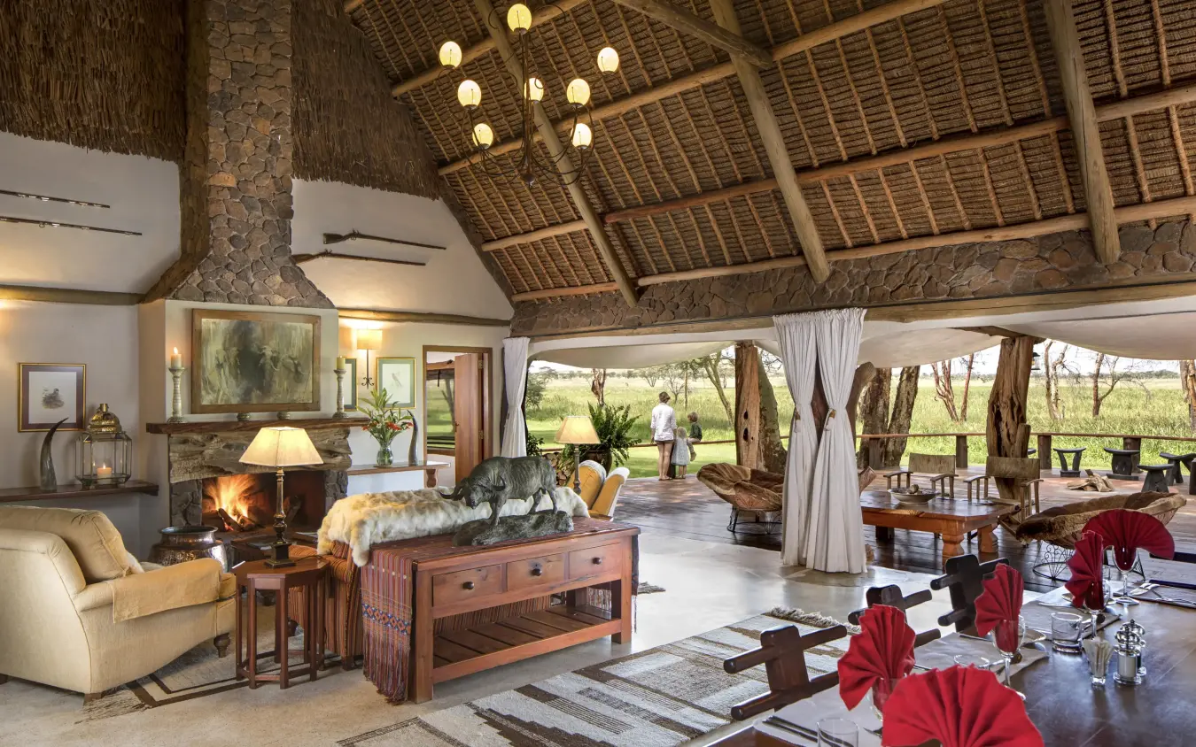 Open-plan lounge with thatch ceiling and fireplace, Sirikoi, Laikipia Highlands, Kenya