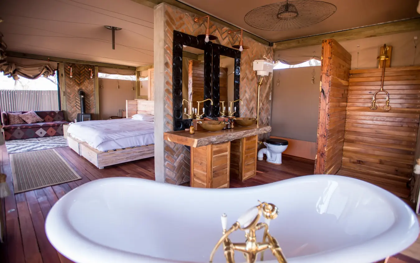 Luxurious bathroom with freestanding tub and wooden vanity, Somalisa Acacia, Hwange National Park, Zimbabwe