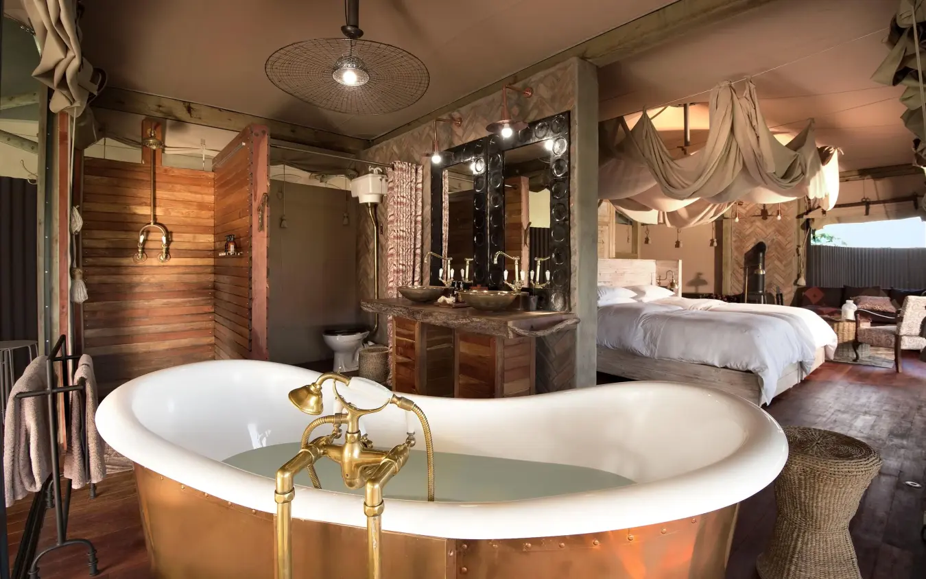 Luxurious bathroom with copper soaking tub and vanity, Somalisa Acacia, Hwange National Park, Zimbabwe