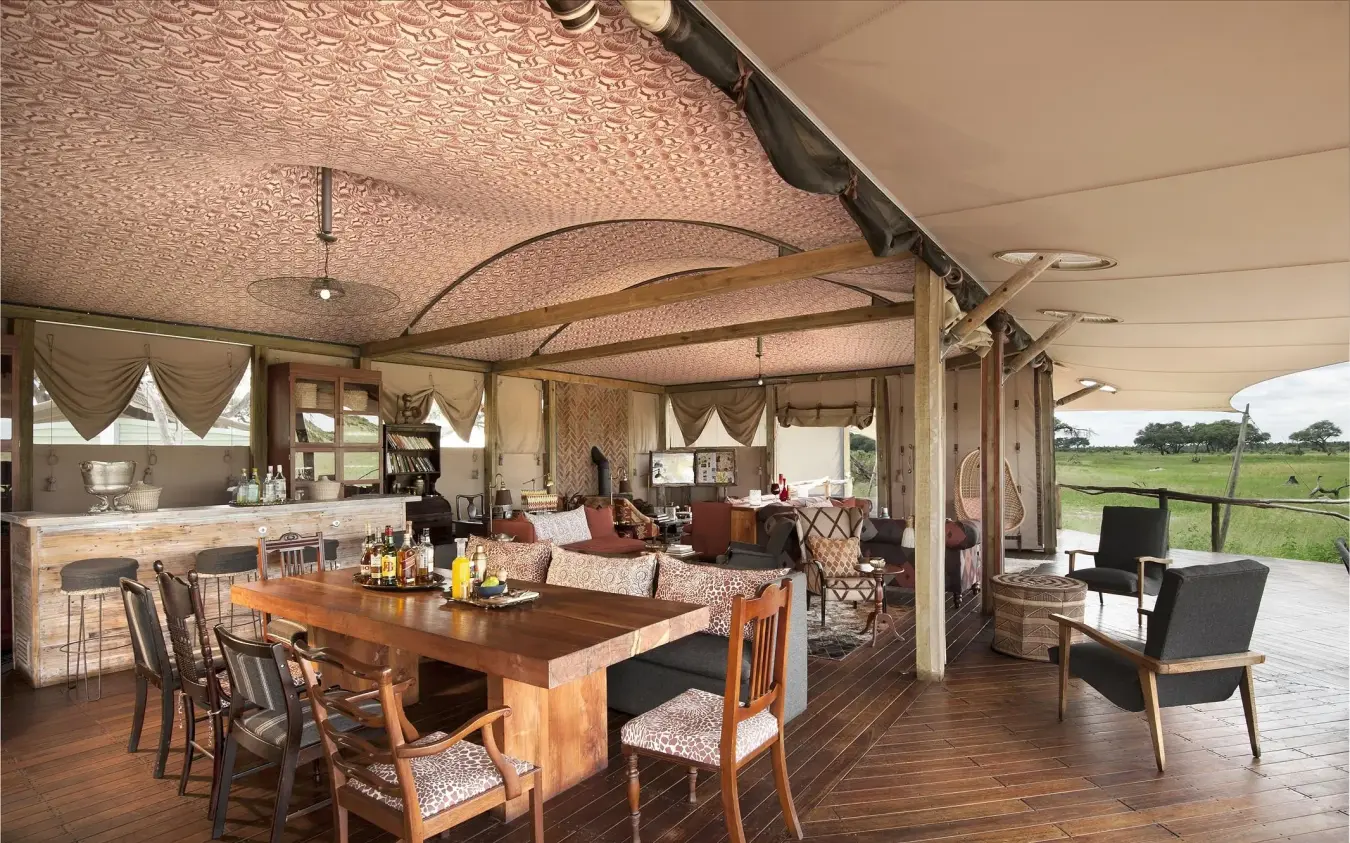 Open-plan lounge with dining area overlooking savanna, Somalisa Acacia, Hwange National Park, Zimbabwe