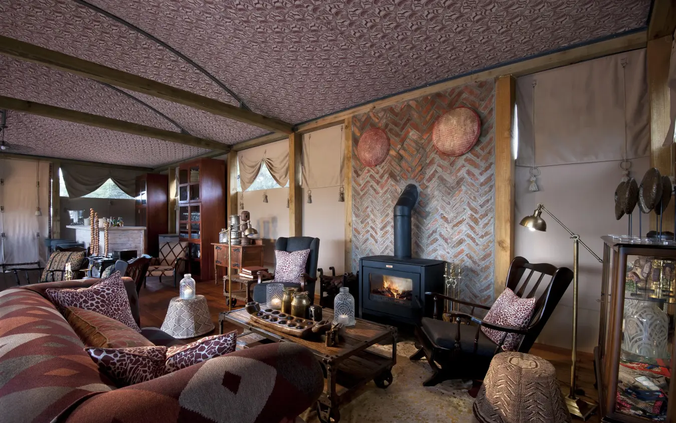 Luxurious safari lodge lounge with fireplace and seating, Somalisa Acacia, Hwange National Park, Zimbabwe