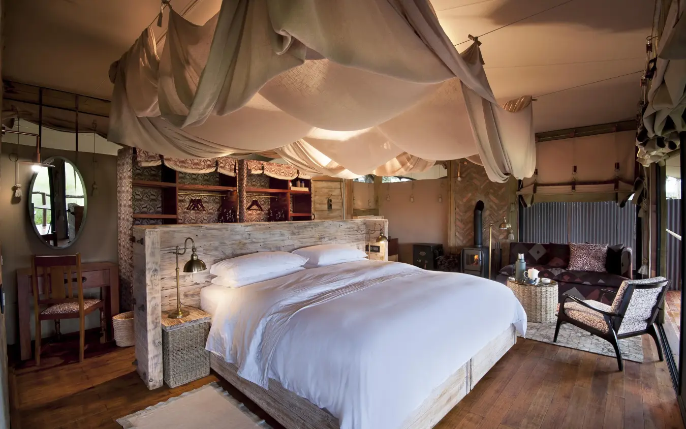 Spacious bedroom with draped canopy bed and seating area, Somalisa Acacia, Hwange National Park, Zimbabwe